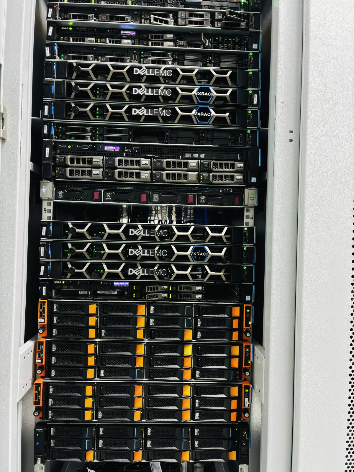 A 42U cabinet in the URLStart cage with Dell EMC servers and storage shelves installed, front door open