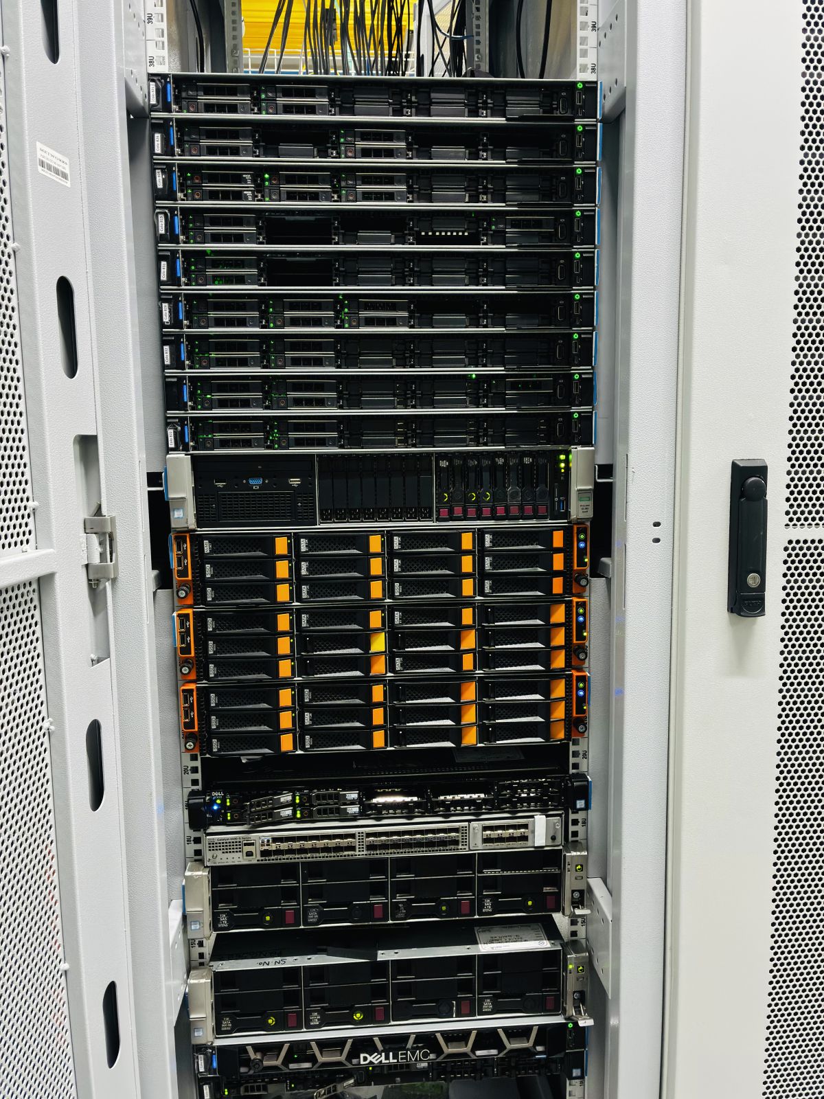 A URLStart cabinet with rows of 1U servers, a storage shelf and a top-of-rack switch, photographed in the Noida datacenter